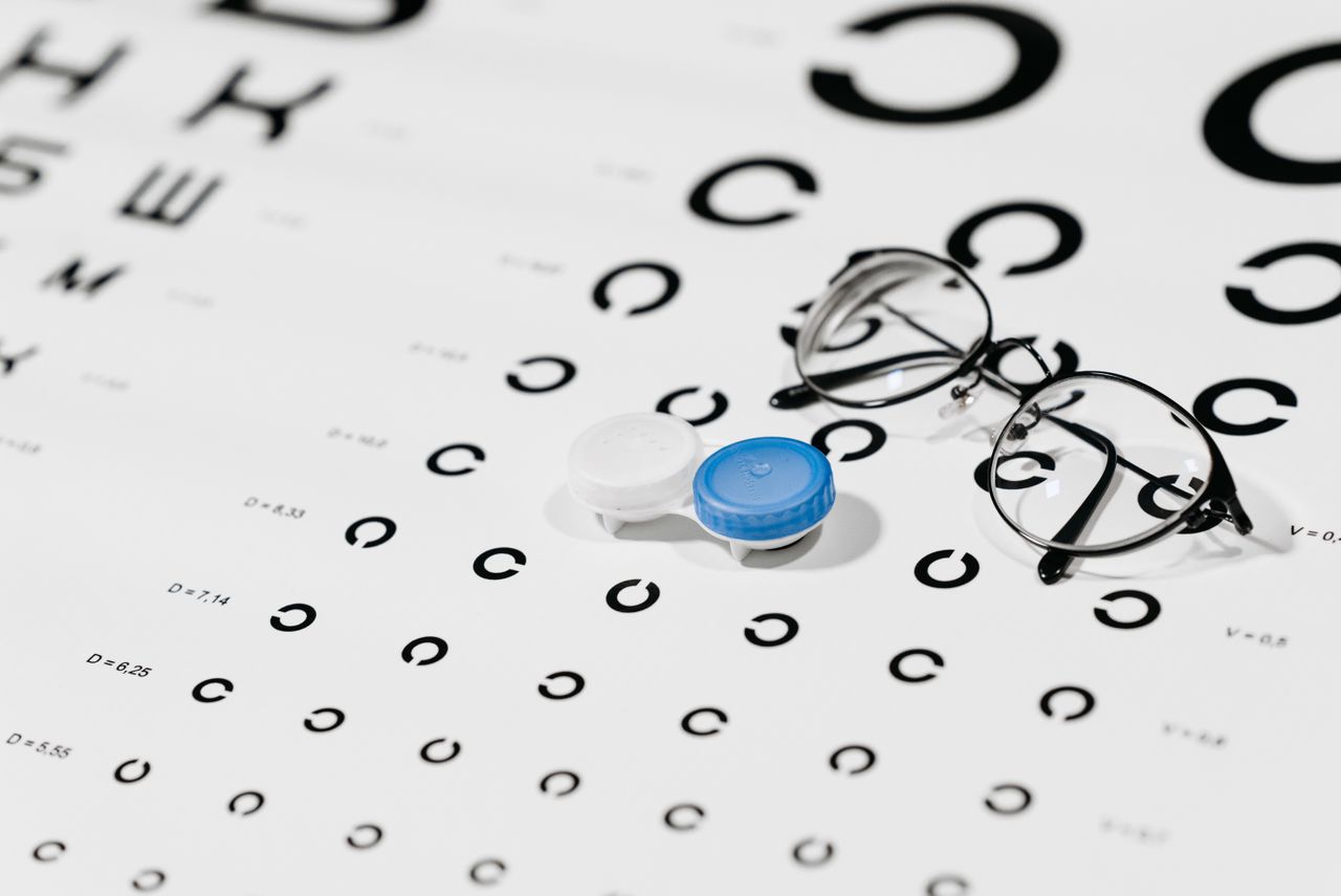 The Art of Drawing Readers In: Your attractive post title goes here Close-up of contact lens case and eyeglasses on an eye test chart, ideal for vision care concepts.